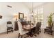 Formal dining room with a large table, elegant chandelier, and bright windows at 12749 E Poinsettia Dr, Scottsdale, AZ 85259