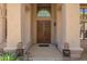 Elegant front door with decorative wreath and covered entry with porch at 12749 E Poinsettia Dr, Scottsdale, AZ 85259