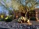 Daytime view of front yard features a desert landscape with mature trees and river rock at 12749 E Poinsettia Dr, Scottsdale, AZ 85259
