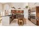 Spacious kitchen with dark wood cabinets, stainless steel appliances, center island and eat-in bar area at 12749 E Poinsettia Dr, Scottsdale, AZ 85259
