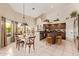 Open kitchen and dining area with stainless steel appliances and breakfast bar at 12749 E Poinsettia Dr, Scottsdale, AZ 85259