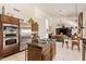 Open concept kitchen with stainless steel appliances, central island, and views to the living room at 12749 E Poinsettia Dr, Scottsdale, AZ 85259