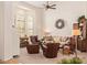 Cozy living room with comfortable seating, plantation shutters, and ample natural light at 12749 E Poinsettia Dr, Scottsdale, AZ 85259