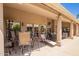 Inviting covered patio with lounge seating, outdoor dining, and scenic views of the backyard at 12749 E Poinsettia Dr, Scottsdale, AZ 85259