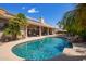 Lush backyard with private pool, rock waterfall, and solar panels on the roof at 12749 E Poinsettia Dr, Scottsdale, AZ 85259