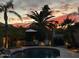 Backyard oasis with a sparkling pool, lush palm trees, and sunset views at 12749 E Poinsettia Dr, Scottsdale, AZ 85259