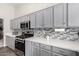 Bright kitchen features gray cabinets, stainless steel appliances, and a stylish backsplash at 1425 E Darrel Rd, Phoenix, AZ 85042