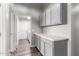 Well-lit laundry room with gray cabinets, white countertop, and modern appliances in a neutral color scheme at 1425 E Darrel Rd, Phoenix, AZ 85042