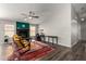 Bright living room featuring fireplace and adjacent workspace with natural light and ceiling fan at 1425 E Darrel Rd, Phoenix, AZ 85042