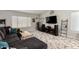Spacious living room with a large TV, comfortable seating, and neutral decor at 1425 E Darrel Rd, Phoenix, AZ 85042