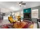 Cozy living room with a fireplace, colorful rug, and open access to the kitchen at 1425 E Darrel Rd, Phoenix, AZ 85042