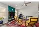 Cozy living room with a decorative fireplace, ceiling fan and cheerful yellow accent chairs at 1425 E Darrel Rd, Phoenix, AZ 85042
