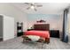 Comfortable main bedroom with a ceiling fan, colorful accent wall, and patterned rug at 1425 E Darrel Rd, Phoenix, AZ 85042