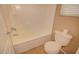Neutral-colored bathroom features tile flooring, a toilet, and a bright white bathtub and shower combination at 1524 N Milly Pl, Casa Grande, AZ 85122