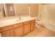 Bathroom with a vanity, sink, tile flooring, toilet, and a combined bathtub and shower with tan-colored walls at 1524 N Milly Pl, Casa Grande, AZ 85122