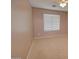 Neutral-toned bedroom with carpet, ceiling fan, and a large window overlooking outside at 1524 N Milly Pl, Casa Grande, AZ 85122