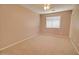 Neutral bedroom with carpet flooring, a ceiling fan, and a window providing natural light at 1524 N Milly Pl, Casa Grande, AZ 85122