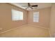 Comfortable bedroom features neutral carpet, ceiling fan, and natural light from the windows at 1524 N Milly Pl, Casa Grande, AZ 85122