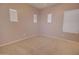 Neutral bedroom offering natural light from multiple windows with light colored carpet flooring at 1524 N Milly Pl, Casa Grande, AZ 85122