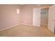 Bedroom features neutral walls, a carpeted floor, and a sliding door to an adjacent room with carpeted flooring at 1524 N Milly Pl, Casa Grande, AZ 85122