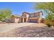 Two-story home with desert landscaping, attached two-car garage, and covered entryway at 1524 N Milly Pl, Casa Grande, AZ 85122