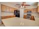 Spacious kitchen with stainless steel appliances, island, and wooden cabinetry at 1524 N Milly Pl, Casa Grande, AZ 85122