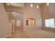Living room with high ceilings, large windows, tile entry, and carpeted floors at 1524 N Milly Pl, Casa Grande, AZ 85122