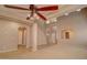 Open-concept living room boasting high ceilings, large fan, archways, and light-colored walls at 1524 N Milly Pl, Casa Grande, AZ 85122