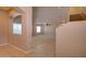 Spacious living room with neutral colored walls and carpet, brightened by natural light streaming through windows at 1524 N Milly Pl, Casa Grande, AZ 85122