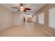 Spacious living room boasts tile flooring, ceiling fan, and natural light pouring in from the windows at 1524 N Milly Pl, Casa Grande, AZ 85122