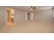 Large main bedroom with neutral carpet, ceiling fan, and bathroom vanity at 1524 N Milly Pl, Casa Grande, AZ 85122