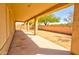 Covered patio area with a view of the backyard and a brick fence at 1524 N Milly Pl, Casa Grande, AZ 85122