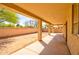 Covered patio area with a view of the backyard and a brick fence at 1524 N Milly Pl, Casa Grande, AZ 85122