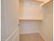Walk-in closet with carpet flooring and wood shelving at 1524 N Milly Pl, Casa Grande, AZ 85122