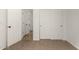 Cozy bedroom featuring neutral carpet, white walls, and a closet with sliding doors at 15656 W Devonshire Ave, Goodyear, AZ 85395