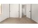Clean bedroom featuring neutral carpet, white walls, and a closet with sliding doors at 15656 W Devonshire Ave, Goodyear, AZ 85395