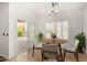 Cozy dining area with a round table, seating for four, and a view of the pool at 15656 W Devonshire Ave, Goodyear, AZ 85395