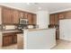 A kitchen featuring granite countertops, stainless steel appliances, and plenty of cabinet space at 15656 W Devonshire Ave, Goodyear, AZ 85395
