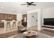Open-concept living area featuring kitchen bar seating and a stylish sectional sofa at 15656 W Devonshire Ave, Goodyear, AZ 85395