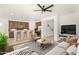 An open-concept living space featuring a comfortable sectional and a kitchen with bar seating at 15656 W Devonshire Ave, Goodyear, AZ 85395