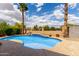 Inviting backyard pool boasts baja step entry, desert landscaping, and a private outdoor space at 15656 W Devonshire Ave, Goodyear, AZ 85395