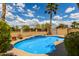 Refreshing backyard pool with baja steps, mature landscaping and a view of the desert community at 15656 W Devonshire Ave, Goodyear, AZ 85395