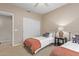 Comfortable bedroom featuring two twin beds, a ceiling fan, and a closet with sliding doors at 16151 W Fairmount Ave, Goodyear, AZ 85395
