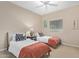 Cozy bedroom featuring two twin beds, a ceiling fan, and a window with natural light at 16151 W Fairmount Ave, Goodyear, AZ 85395