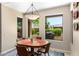 Inviting dining area with views of the outside through expansive windows for a bright, airy feel at 16151 W Fairmount Ave, Goodyear, AZ 85395