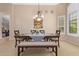 Elegant dining room featuring a modern chandelier and a comfortable bench, perfect for Gathering meals at 16151 W Fairmount Ave, Goodyear, AZ 85395