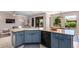 Well-equipped kitchen with blue cabinets and a spacious counter, offering ample room for cooking and entertaining at 16151 W Fairmount Ave, Goodyear, AZ 85395