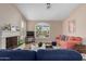 Cozy living room featuring a fireplace, large windows, and comfortable seating, perfect for Gathering gatherings at 16151 W Fairmount Ave, Goodyear, AZ 85395
