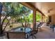Relax on this covered patio with serene backyard views, perfect for outdoor dining and lounging at 16151 W Fairmount Ave, Goodyear, AZ 85395