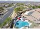 Aerial view of a home with a private pool, solar panels, landscaped yard, and neighborhood views at 16511 W Cortez St, Surprise, AZ 85388